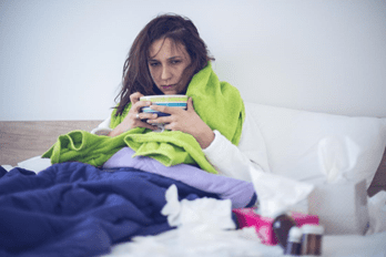 Image of person in bed with flu